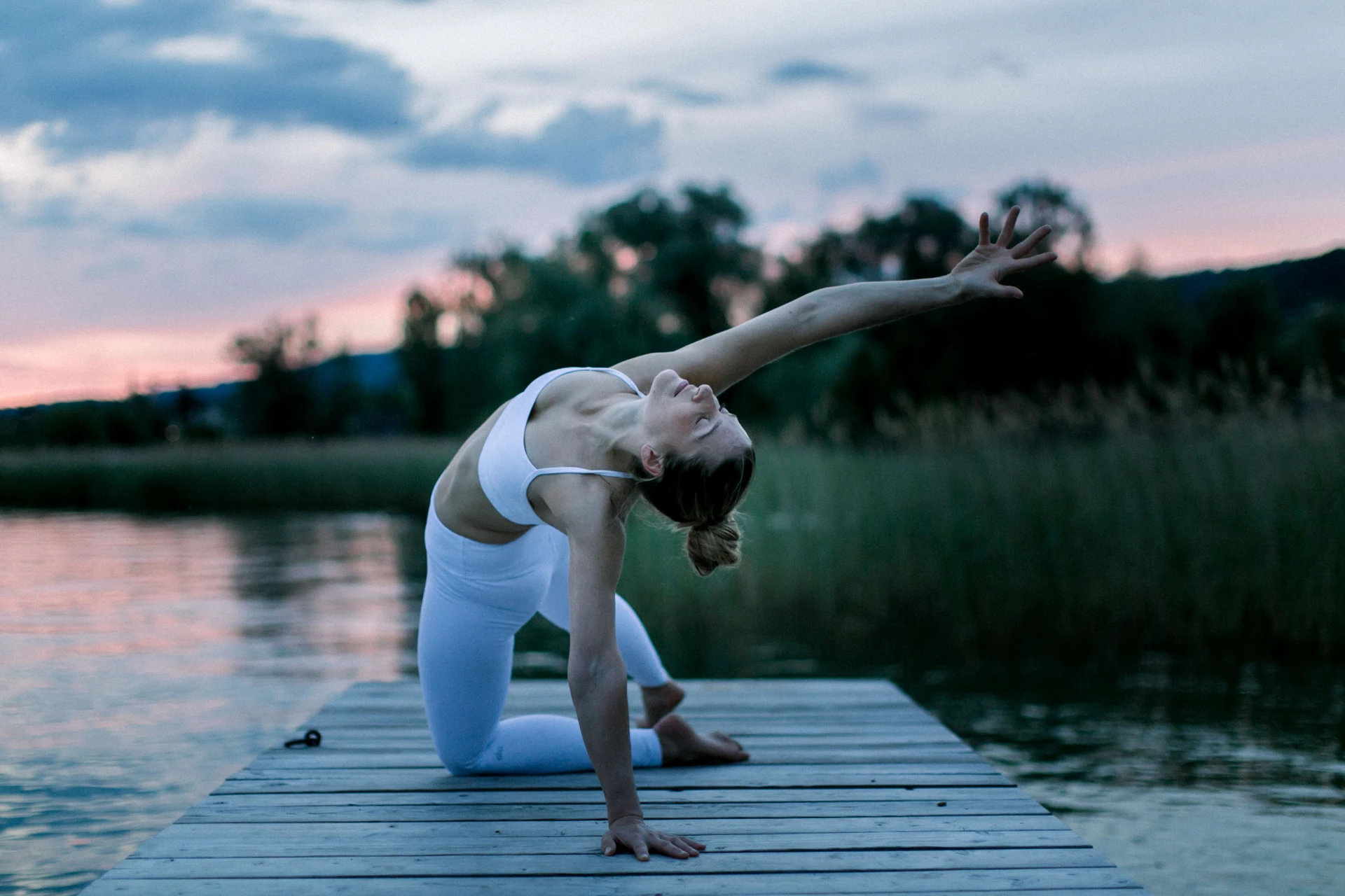 Lisa Lange bei einer seitlichen Yogadehnung am See